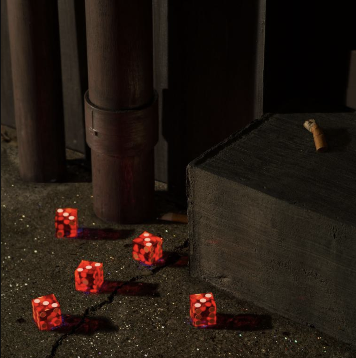 The cover art for Bright Eyes’ new album, Five Dice All Threes, features five dice with all threes sprawled across a dimly lit sidewalk. (Courtesy of Genius)

